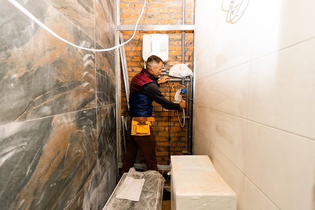 Plumber repairing an hot-water heater
