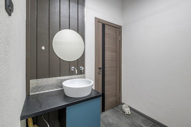Toilet and detail of a corner shower cabin with wall mount shower attachment